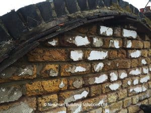 Repairs and repointing required to bricks and tiles above the dutch gable