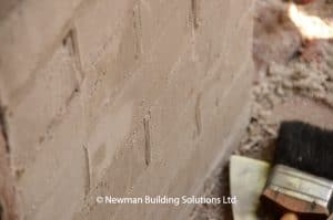 Close up showing texture of brick repairs.