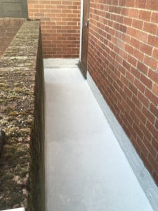 External walkway coated in Polyac Rapid prior to broadcasting with natural quartz